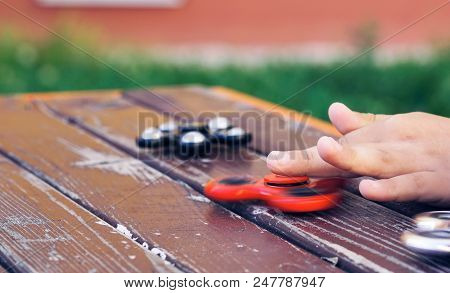 Little Boy's Hands Playing With A Fidget Spinner Close-up. Popular And Trendy Toy For Children And A