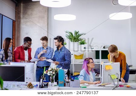 Well-lit White Open Office Space With White Furniture Computer Tables With Digital Gadgets. Multirac