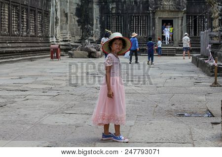 Siem Reap, Cambodia - 22 March 2018: Cambodian Girl In Angkor Wat Temple. Pretty Girl In Pink Dress 