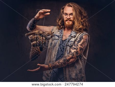 Portrait Of A Tattoed Redhead Hipster Male With Long Luxuriant Hair And Full Beard Dressed In A T-sh