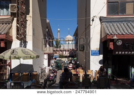 Dunhuang, China - August 7, 2012: Street Scene In The City Of Dunhuang, With People On A Stree And A
