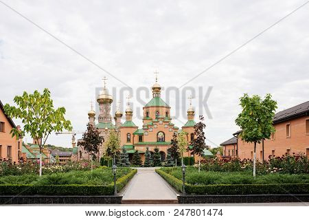 The Big Christian Temple With Domes And The Green Yard