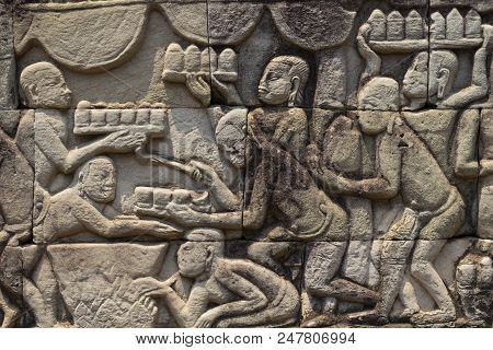 Ancient Temple Stone Carved Bas-relief In Angkor Wat. Cooking People Bas-relief Closeup. Angkor Wat 