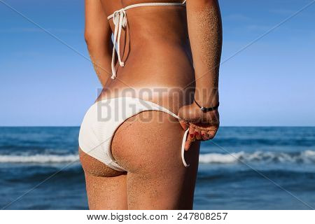 Beautiful Girl Buttocks On A Blue Sea Background