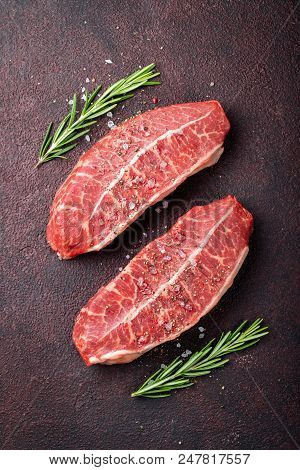 Raw Fresh Meat Top Blade Steaks On Dark Background. Top View.