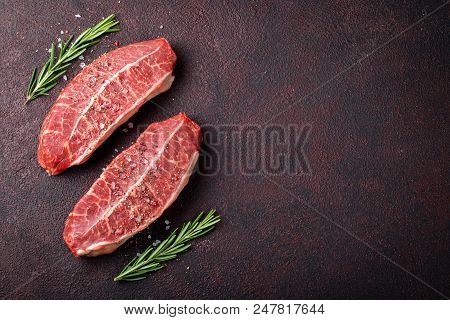 Raw Fresh Meat Top Blade Steaks On Dark Background. Top View With Copy Space.
