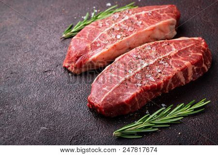 Raw Fresh Meat Top Blade Steaks On Dark Background. Top View With Copy Space.