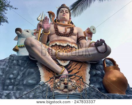 Bangalore India : Big Lord Shiva Statue Sitting On Rock With Trident And Damaru (small Two-headed Dr