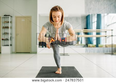 Close-up Of Charming Young Woman In A Black Suit Doing Sophisticated Yoga Exercise Stand On One Leg 