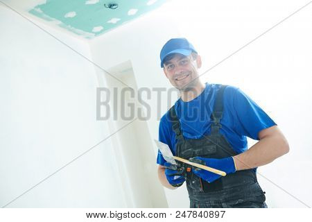refurbishment. happy plasterer portrait with tools