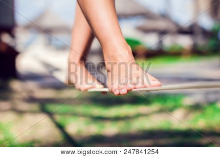 Sport, Leisure, Recreation And Healthy Active Lifestyle Concept - Woman Slacklining Walking And Bala
