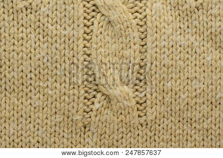 Knit Texture Of Beige Wool Knitted Sweater With Cable Knits Pattern.