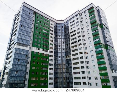 Aerial View Of A Tall Skyscraper In Green Color In The Form F A Coner