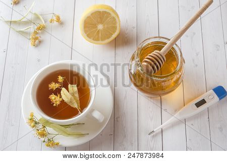 Tea With Linden, Honey And Lemon. Healthy Food, Treatment Of Colds Thermometer On The Table