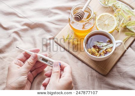 Tea With Linden, Honey And Lemon. The Tray On The Bed, The Concept Of The Treatment Of Colds. Thermo