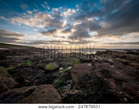 Hdr Wide Angle View Of The Rockey Coastline Of The Most Northern Area Of Scotland Set Against A Dusk