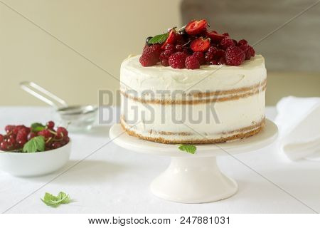 Summer Home Biscuit Cake With Curd Cream, Decorated With Fresh Berries Of Strawberries, Raspberries 