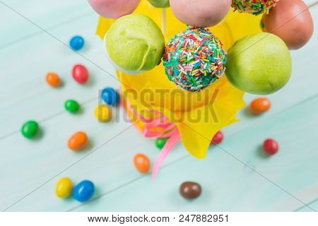 A Lot Of Colored Popcakes In A Glass On Turquoise Boards, Top View, Macro Photograph, Scattered Colo