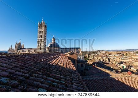 Siena Cathedral (santa Maria Assunta) 1220-1370 With Clear Blue Sky And Cityscape. Toscana (tuscany)