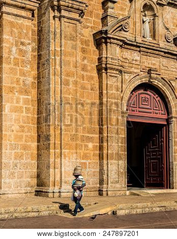 Cartagena, Colombia. March 2018. A View Of A Hat Seller Outside The Cathedral San Pedro Claver In Ca