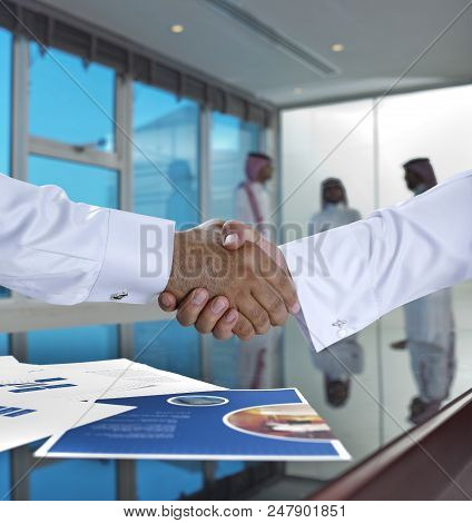 Saudi Arab Businessmen Shaking Hands, And Making Agreement Or A Deal