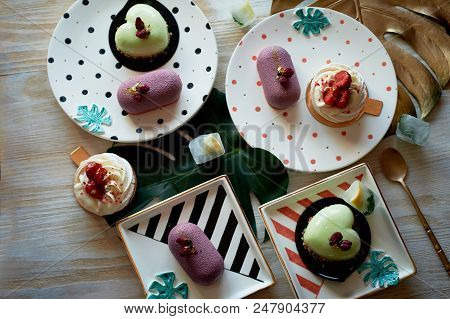 Moscovie Cakes Purple And Lemon Yellow. Pistachio And Fruit. Meringue Anna Pavlova . Culinary Art. O