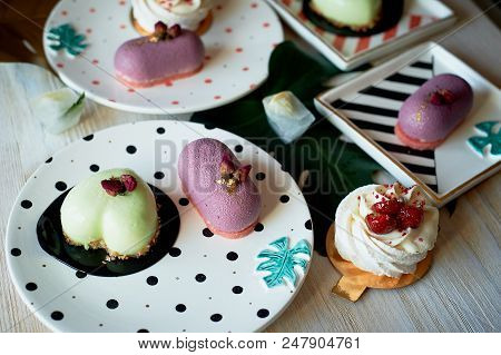 Moscovie Cakes Purple And Lemon Yellow. Pistachio And Fruit. Meringue Anna Pavlova . Culinary Art. O