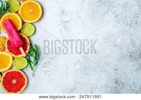 Homemade Citrus Popsicles With Fresh Fruit Slices On Stone Table Background Top View Mockup