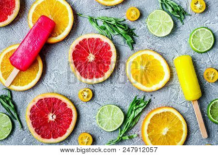 Homemade Citrus Popsicles With Fresh Fruit Slices On Stone Table Background Top View Pattern