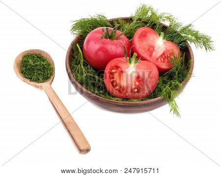 Three Ripe Tomatoes Are Lying On The Plate, Surrounded By The Fresh Dill. There Is A Wooden Spoon Wi