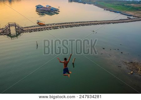 Asian Guy Jump From Mon Bridge In Sangkhlaburi Kanchanaburi Bangkok Thailand,famous Jumping Point Fr