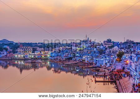 Pushkar Holy Lake At Sunset. Hindu Pilgrims Bathing In Sacred Lake Pushkar (sarovar) On Ghats. Count