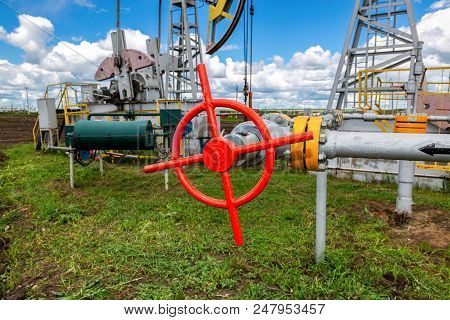 Pipeline With Control Valve Against The Background Pump Jack Fracking Crude Extraction Machine