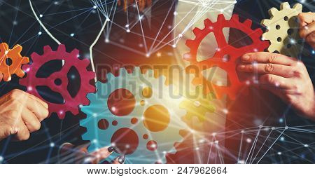 Teamwork Of Businesspeople Work Together And Combine Pieces Of Gears. Partnership And Integration Co