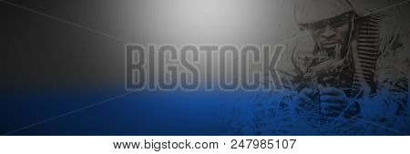 Military soldier guarding with rifle on grassy field in boot camp