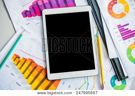 Empty Tablet On The Table With Paper Chart
