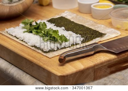 Chef Preparing Ingredients And Teaching How To Make Sushi
