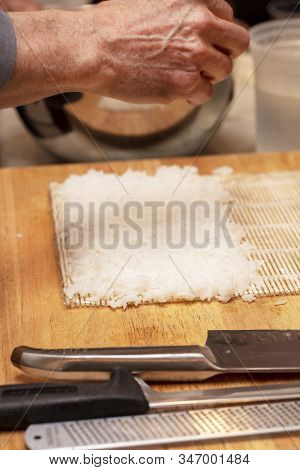 Sushi Roll Demonstration On How To Place Ingredients For An Outside Sushi Roll, With Rice And Seawee