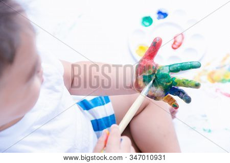 Happy Asian Baby Child Use Paintbrush Draw Water Color Or Fingerpaint On Hand Oneself, Baby 2-3 Year