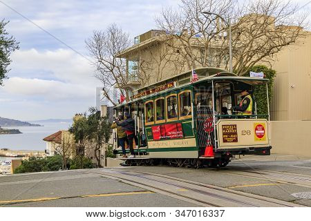 San Francisco, Usa - January 21, 2020: Tourists Riding The Iconic Cable Car At The Top Of Hyde Stree