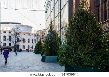 Helsinki, Finland - November 30, 2019: Outdoor Street View Of Illuminated Christmas Trees Outside Th