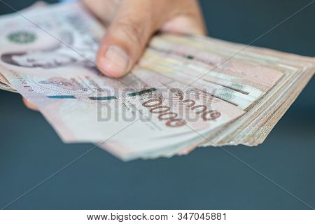 Blurred Of Stack Thai Baht Banknotes, One Thousand Baht With Tag Text In Thai Word. (thb) Is Officia