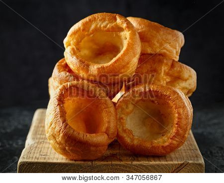 Traditional English Yorkshire Pudding Side Dish On Black Plate And Background