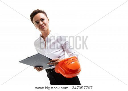Caucasian Woman With Short Dark Hair, In Beautiful Office Suit, Orange Comstruction Helmet Plans Som
