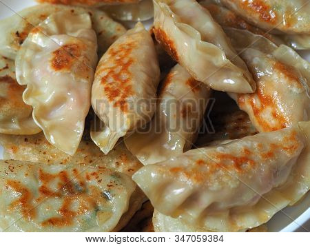 Dumplings Are Fried In A Pan. Asian Dish With A Variety Of Fillings. Fried Gyoza. Close Up, Top View