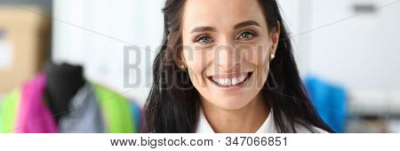 Portrait Of Gorgeous Woman Standing Indoors And Looking At Camera With Calmness And Happiness. Joyfu