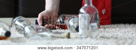 Focus On Man Hand Holding Bottle Of Expensive Alcohol In Indoors And Having Extreme Hangover After R