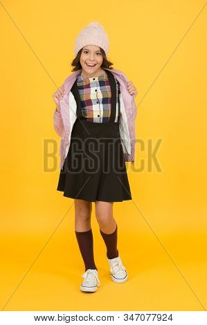 Welcome To School. Small Girl In Uniform. Cheerful Child Yellow Background. Beauty And Fashion For K