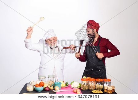 Two Chefs Cooking On Kitchen. Professional Culinary. Bearded Man In Kitchen Apron. Bearded Man Chef 