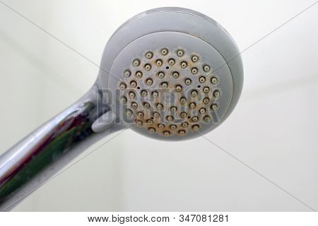 Old Shower Head With Plaque. Dirty Plastic Shower Head. Limescale Coating On Plumbing.